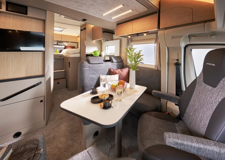 Innenraum eines Bürstner Campeo TD 690 Wohnmobils mit gemütlicher Sitzgruppe .